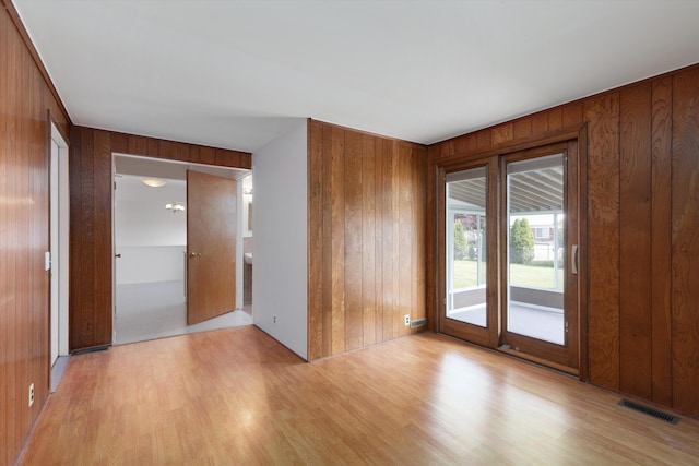 3604 Pall Dr, Warren, MI 48092 - empty room featuring wooden walls and light wood-style flooring