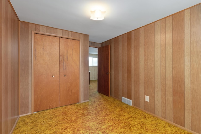 3604 Pall Dr, Warren, MI 48092 - unfurnished bedroom featuring a closet, carpet, and wood walls