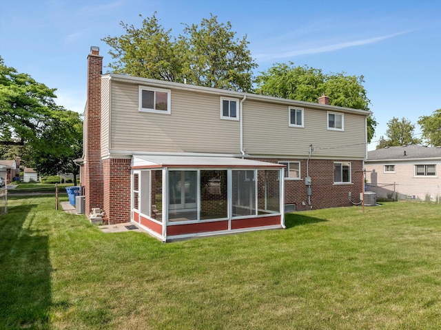 3604 Pall Dr, Warren, MI 48092 - back of property with a chimney, a sunroom, central air condition unit, and brick siding