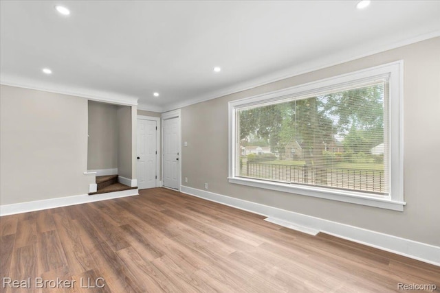 16810 Archdale St, Detroit, MI 48235 - unfurnished living room with plenty of natural light, crown molding, baseboards, recessed lighting, and wood finished floors