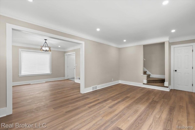 16810 Archdale St, Detroit, MI 48235 - empty room with ornamental molding, baseboards, a chandelier, stairway, and wood finished floors