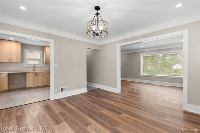 16810 Archdale St, Detroit, MI 48235 - unfurnished dining area with wood finished floors, a sink, plenty of natural light, ornamental molding, and recessed lighting