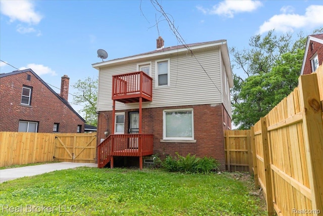 16810 Archdale St, Detroit, MI 48235 - back of house with a balcony, a gate, brick siding, and a chimney