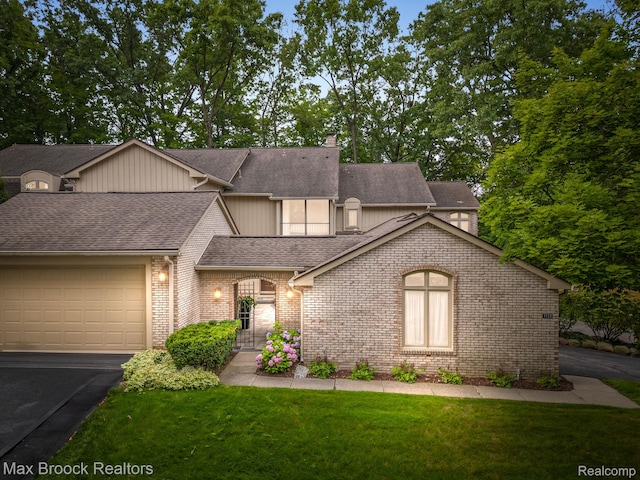 1132 Hillpointe Cir, Bloomfield Hills, MI 48304 - view of front facade with a shingled roof, an attached garage, a front yard, brick siding, and driveway