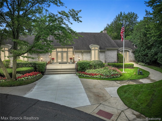 1132 Hillpointe Cir, Bloomfield Hills, MI 48304 - french country home featuring french doors, roof with shingles, brick siding, and a chimney