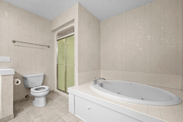 6286 Red Fox Run, Traverse City, MI 49686 - full bathroom with toilet, wallpapered walls, a tub with jets, tile patterned floors, and a stall shower