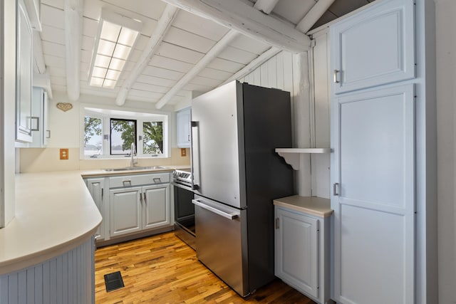 1931 Charlotte Landing Rd, Springport, MI 49284 - kitchen with appliances with stainless steel finishes, a sink, light wood finished floors, and light countertops