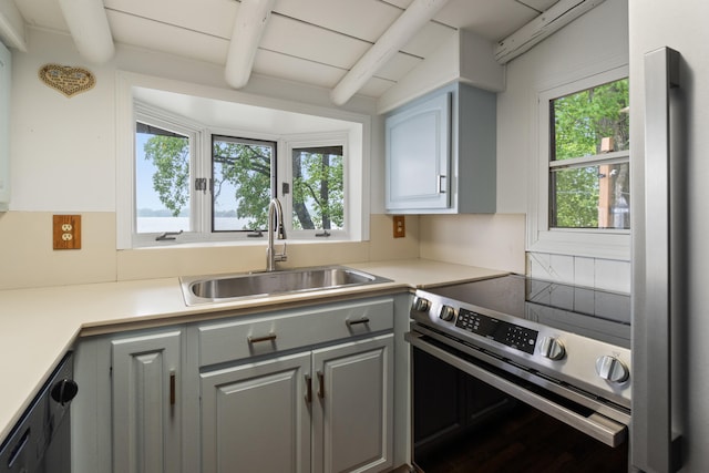 1931 Charlotte Landing Rd, Springport, MI 49284 - kitchen featuring stainless steel range with electric stovetop, a sink, beamed ceiling, healthy amount of natural light, and gray cabinetry