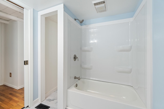 1931 Charlotte Landing Rd, Springport, MI 49284 - bathroom featuring baseboards,  shower combination, and wood finished floors