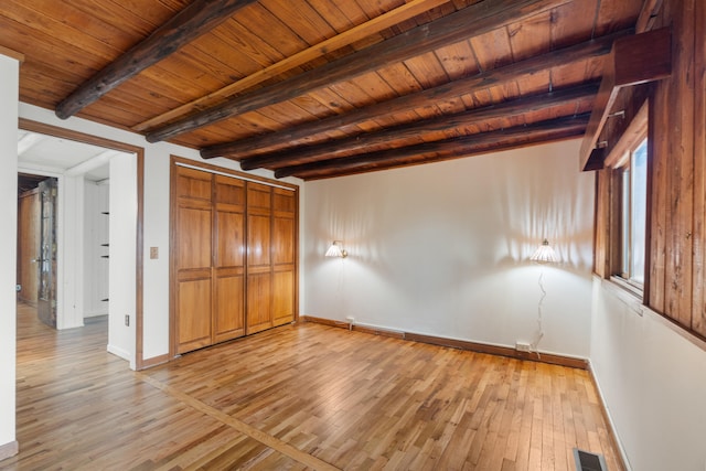 1931 Charlotte Landing Rd, Springport, MI 49284 - unfurnished bedroom with light wood-style flooring, baseboards, wood ceiling with exposed beams, and a closet