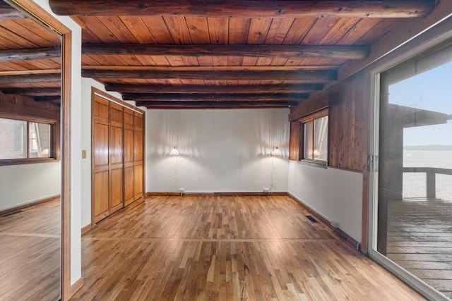 1931 Charlotte Landing Rd, Springport, MI 49284 - unfurnished bedroom featuring wooden ceiling with exposed beams, baseboards, and hardwood / wood-style floors