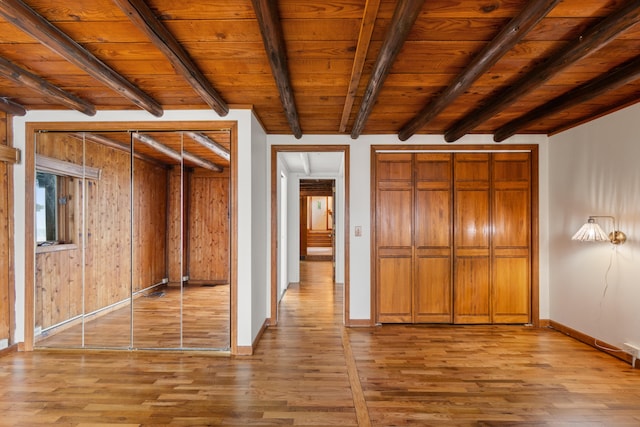 1931 Charlotte Landing Rd, Springport, MI 49284 - unfurnished bedroom with light wood-style flooring, baseboards, and wooden ceiling with exposed beams