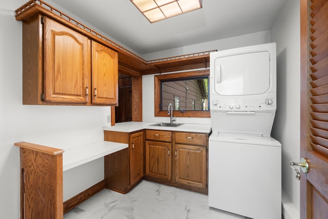 1931 Charlotte Landing Rd, Springport, MI 49284 - laundry area with stacked washer and clothes dryer, cabinet space, and light marble finish floors