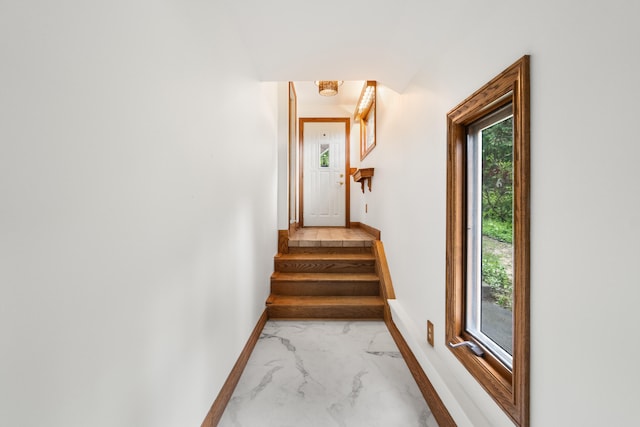 1931 Charlotte Landing Rd, Springport, MI 49284 - stairs with marble look tile flooring and baseboards