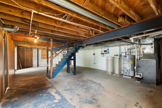 1931 Charlotte Landing Rd, Springport, MI 49284 - unfinished below grade area with water heater, stairs, a water softener system, and heating unit