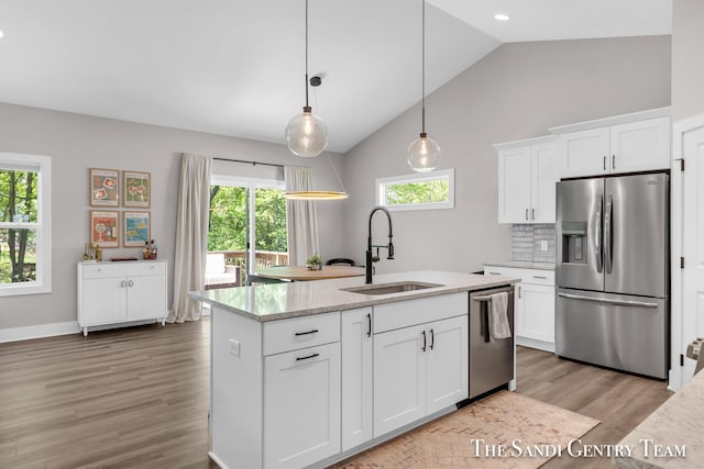 16371 Wickshire Pl, Spring Lake, MI 49456 - kitchen with appliances with stainless steel finishes, a sink, light wood-style floors, healthy amount of natural light, and high vaulted ceiling