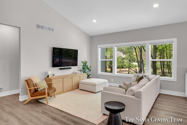 16371 Wickshire Pl, Spring Lake, MI 49456 - living room with high vaulted ceiling, plenty of natural light, wood finished floors, baseboards, and recessed lighting