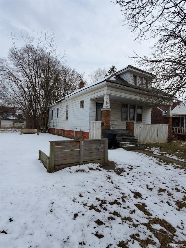 18430 Westphalia St, Detroit, MI 48205 - view of front of home with a chimney, a porch, and brick siding
