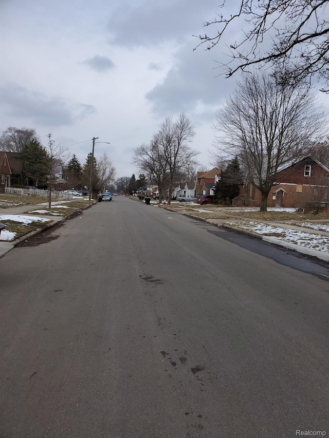 18430 Westphalia St, Detroit, MI 48205 - view of asphalt street with sidewalks, a residential view, curbs, and street lights