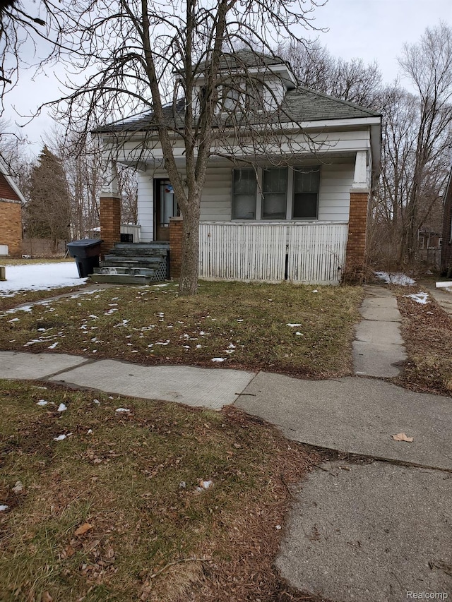 18430 Westphalia St, Detroit, MI 48205 - view of front of property with a porch, roof with shingles, and brick siding