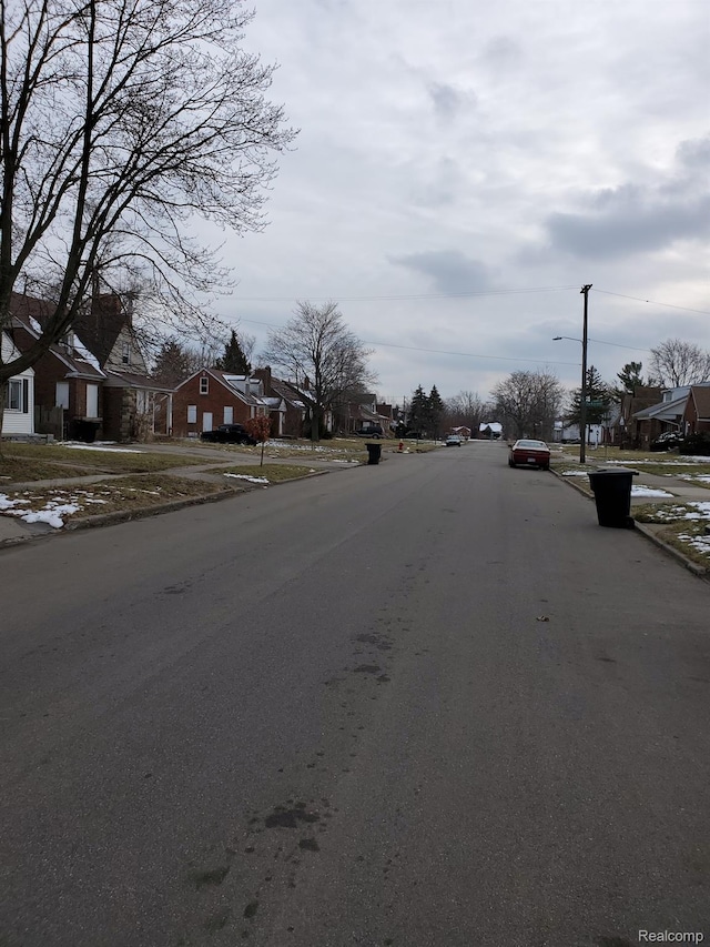 18430 Westphalia St, Detroit, MI 48205 - view of asphalt road with a residential view, sidewalks, curbs, and street lighting