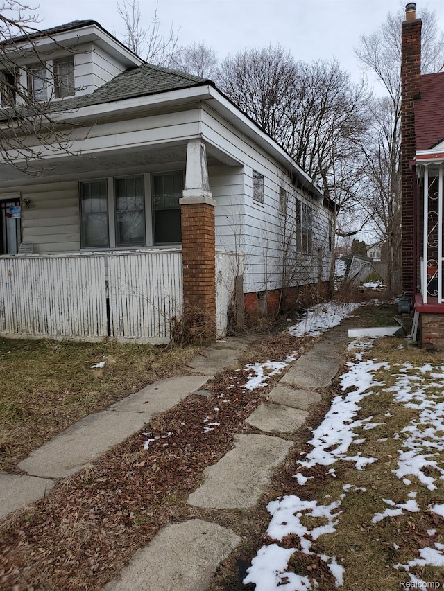 18430 Westphalia St, Detroit, MI 48205 - view of snowy exterior with covered porch