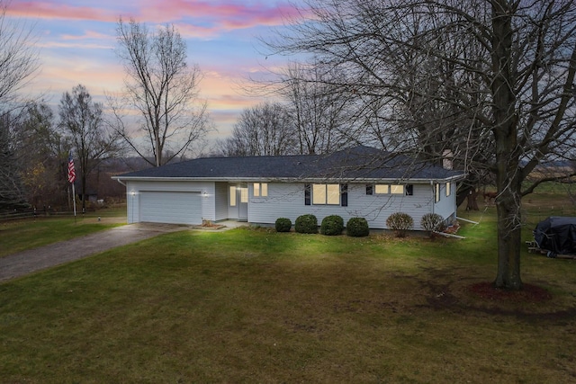 13405 Ellis Rd, Conklin, MI 49403 - ranch-style house with driveway, a garage, and a front yard