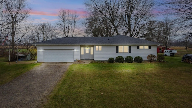 13405 Ellis Rd, Conklin, MI 49403 - ranch-style house with asphalt driveway, a garage, and a front yard