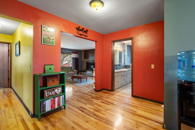 13405 Ellis Rd, Conklin, MI 49403 - corridor featuring hardwood / wood-style flooring, baseboards, and a sink