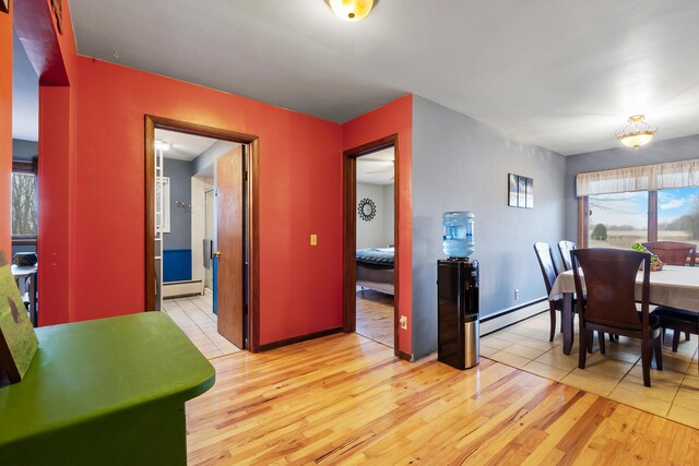 13405 Ellis Rd, Conklin, MI 49403 - dining space featuring a baseboard radiator, light wood-style flooring, baseboard heating, and baseboards