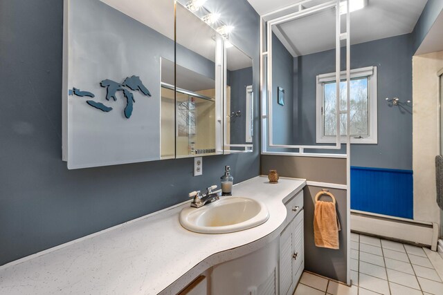 13405 Ellis Rd, Conklin, MI 49403 - bathroom with a baseboard heating unit, vanity, tile patterned floors, and a shower with door