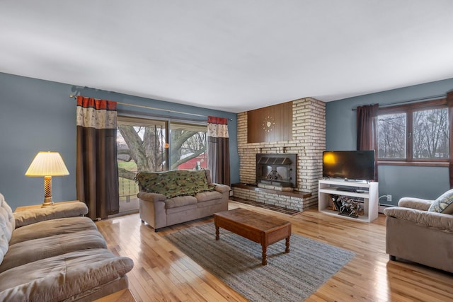 13405 Ellis Rd, Conklin, MI 49403 - living room with light wood finished floors and a brick fireplace