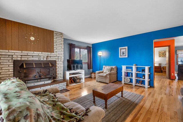 13405 Ellis Rd, Conklin, MI 49403 - living room with a baseboard heating unit and hardwood / wood-style floors