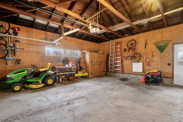 13405 Ellis Rd, Conklin, MI 49403 - garage with a garage door opener and wooden walls