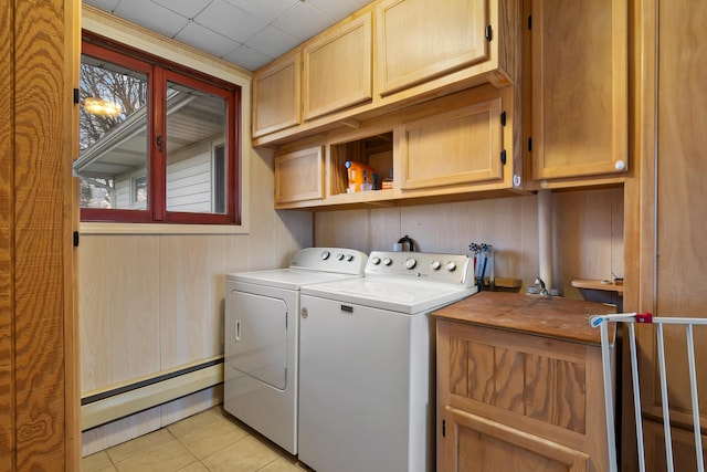 13405 Ellis Rd, Conklin, MI 49403 - laundry room with cabinet space, washer and clothes dryer, a baseboard radiator, light tile patterned flooring, and wooden walls