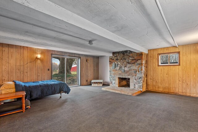 13405 Ellis Rd, Conklin, MI 49403 - bedroom featuring multiple windows, wood walls, carpet, access to outside, and beamed ceiling