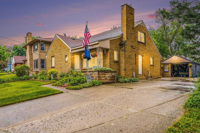 740 Halena St NE, Grand Rapids, MI 49505 - view of front of property with a chimney, an outdoor structure, driveway, and brick siding
