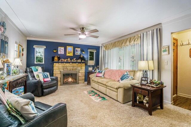 740 Halena St NE, Grand Rapids, MI 49505 - carpeted living room featuring ceiling fan, crown molding, a fireplace, and baseboards