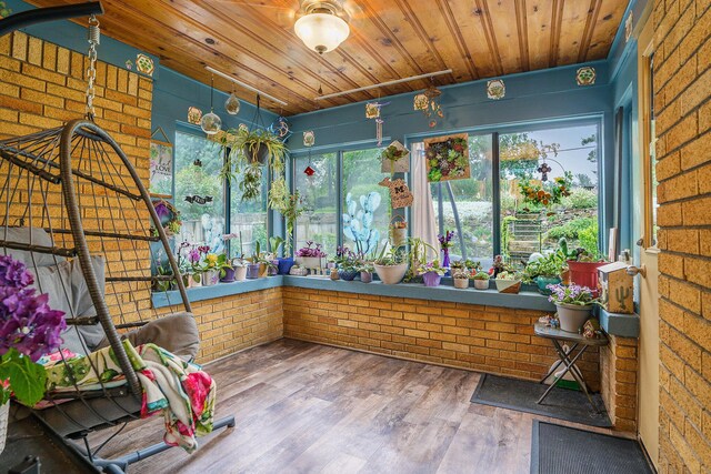 740 Halena St NE, Grand Rapids, MI 49505 - unfurnished sunroom featuring plenty of natural light, wood ceiling, brick wall, and wood finished floors