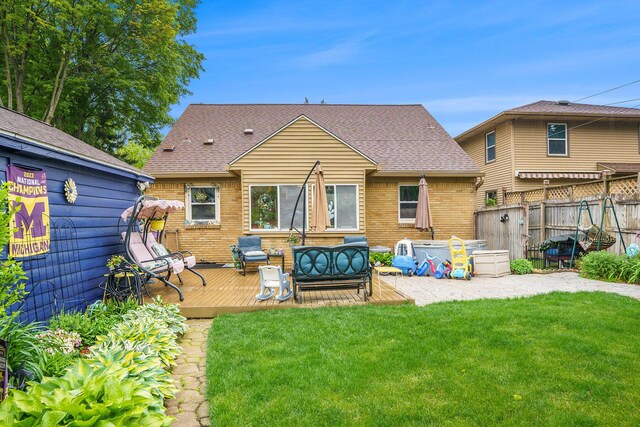 740 Halena St NE, Grand Rapids, MI 49505 - back of house with a wooden deck, brick siding, and roof with shingles