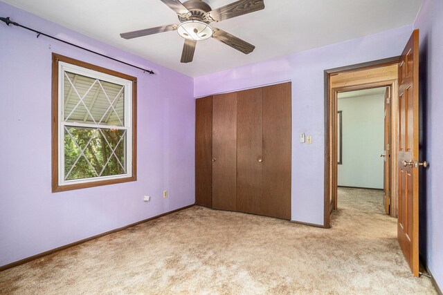 18930 G Dr N, Marshall, MI 49068 - unfurnished bedroom with light colored carpet, a closet, baseboards, and ceiling fan