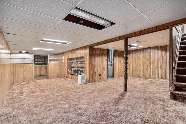 18930 G Dr N, Marshall, MI 49068 - finished basement featuring wood walls, stairway, a paneled ceiling, and carpet floors