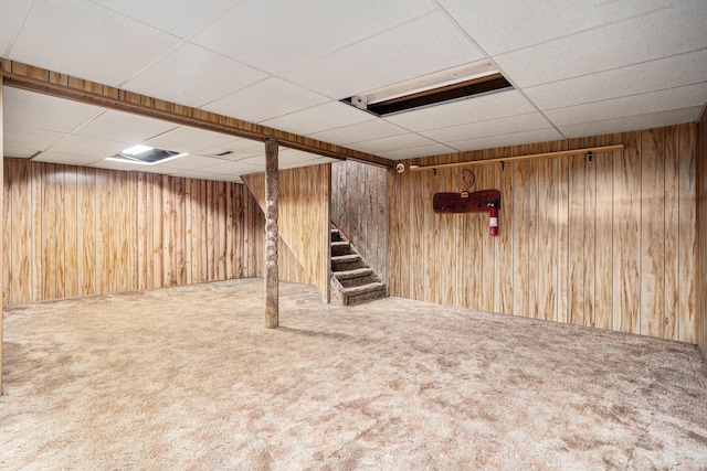 18930 G Dr N, Marshall, MI 49068 - finished below grade area featuring a paneled ceiling, carpet, stairway, and wooden walls