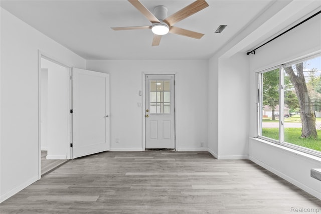 3120 Stratford St, Flint, MI 48504 - unfurnished room featuring healthy amount of natural light, ceiling fan, light wood finished floors, and baseboards