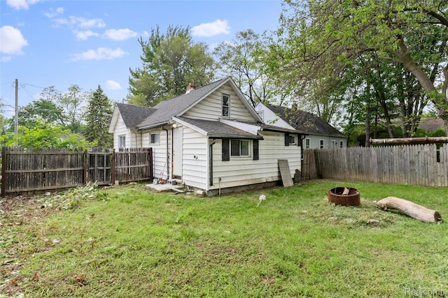 3120 Stratford St, Flint, MI 48504 - rear view of property with an outdoor fire pit and roof with shingles