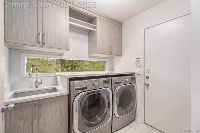 4825 Mirror Lake Dr, West Bloomfield, MI 48323 - laundry area featuring cabinet space, separate washer and dryer, light tile patterned floors, and a textured ceiling