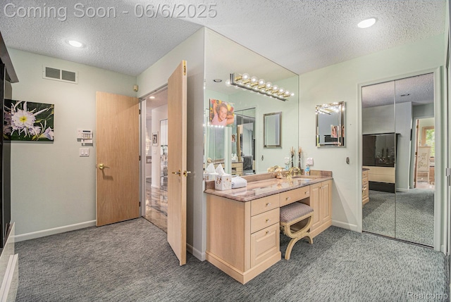 4825 Mirror Lake Dr, West Bloomfield, MI 48323 - bathroom with a textured ceiling, vanity, baseboards, and recessed lighting