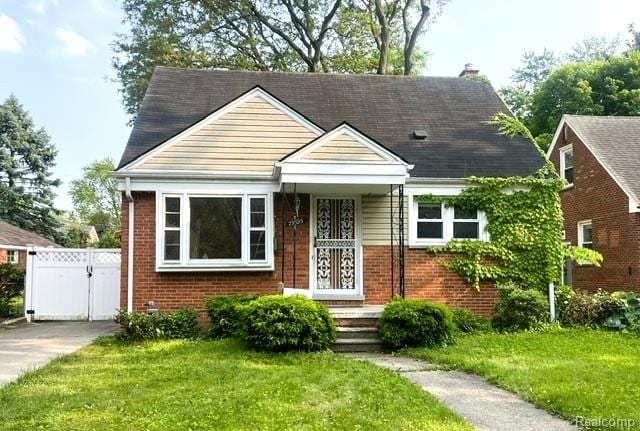 25695 Orchard Dr, Dearborn Heights, MI 48125 - bungalow featuring brick siding, a gate, and a chimney