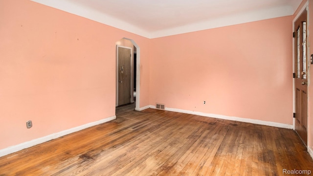 25695 Orchard Dr, Dearborn Heights, MI 48125 - empty room featuring arched walkways and hardwood / wood-style floors