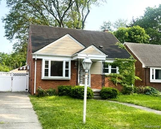 25695 Orchard Dr, Dearborn Heights, MI 48125 - bungalow-style home with a gate and brick siding